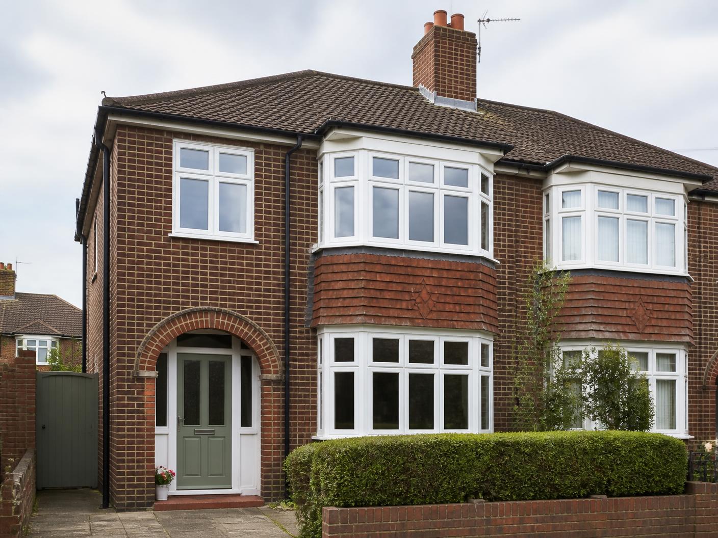 1930s British semi-detached home with white replacement windows